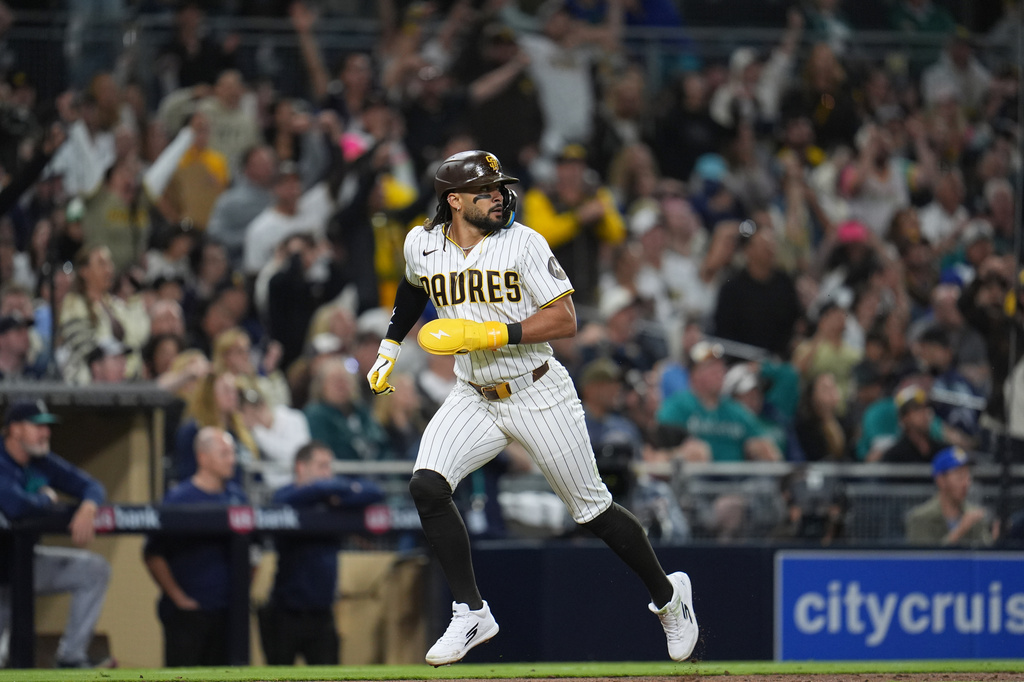 San Diego Padres' Fernando Tatis Jr. scores from third base off an RBI single during the seventh inning of a baseball game against the Seattle Mariners Thursday, April 16, 2026, in San Diego. (AP Photo/Gregory Bull)