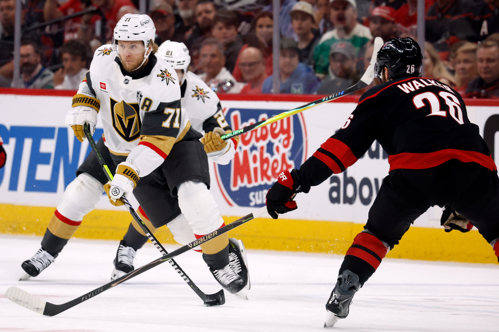 William Karlsson (71) moves the puck around Carolina Hurricanes' Sean Walker (26) during the first period in Game 5 of the NHL hockey Stanley Cup Final series in Raleigh, N.C., Thursday, June 11, 2026. (AP Photo/Karl DeBlaker)