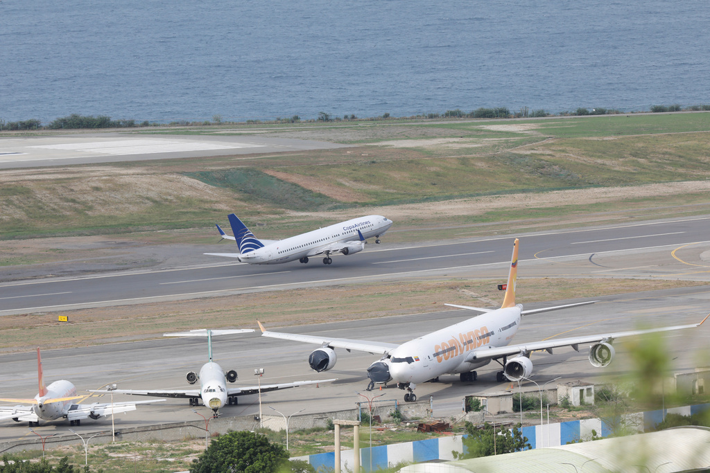 A COPA Airlines plane takes off at Simon Bolivar International Airport in Maiquetia, Venezuela, Monday, Dec. 1, 2025, days after the government revoked operating rights for international airlines that suspended flights following a warning from the U.S. Federal Aviation Administration.(AP Photo/Cristian Hernandez)
