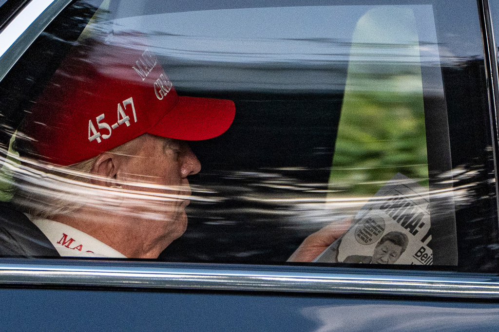 FILE - President Donald Trump reads a copy of the New York Post as he arrives at Trump National Golf Club in Jupiter, Fla., April 5, 2025. (AP Photo/Alex Brandon, File)