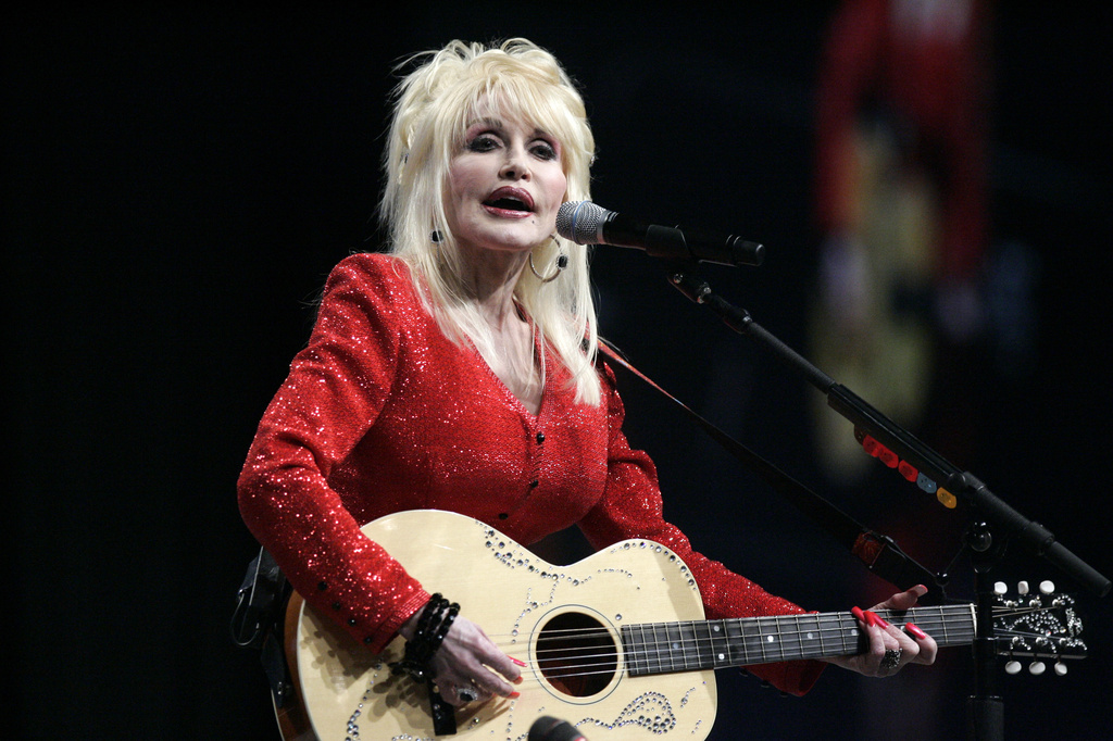 FILE - Dolly Parton performs at a United Way of America convention in Detroit, Friday, May 15, 2009. (AP Photo/Carlos Osorio, File)