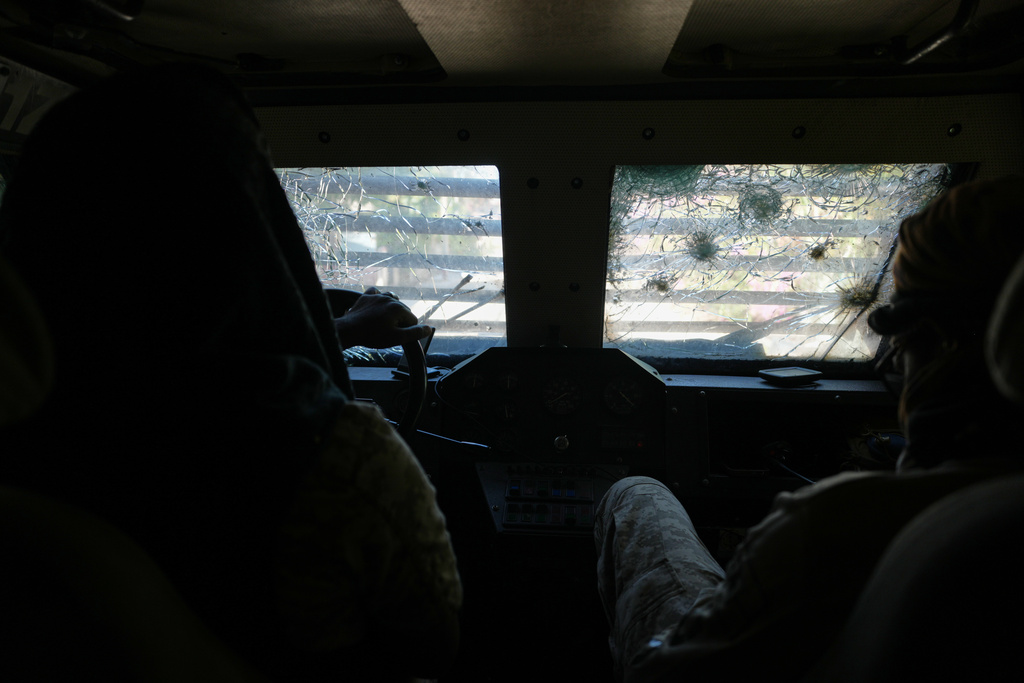 Police in an armored vehicle with a bullet hole-ridden windshield patrol a gang-controlled area of Port-au-Prince, Haiti, Monday, Jan. 19, 2026. (AP Photo/Odelyn Joseph)