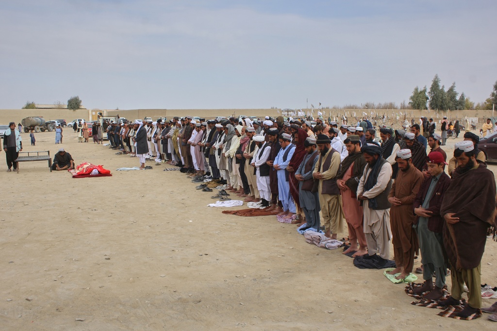Afghans pray during the funeral of a man killed during an overnight exchange of fire between Afghan and Pakistani forces along the border in Spin Boldak, Kandahar province, Afghanistan, Saturday, Dec. 6, 2025. (AP Photo/Sibghatullah)