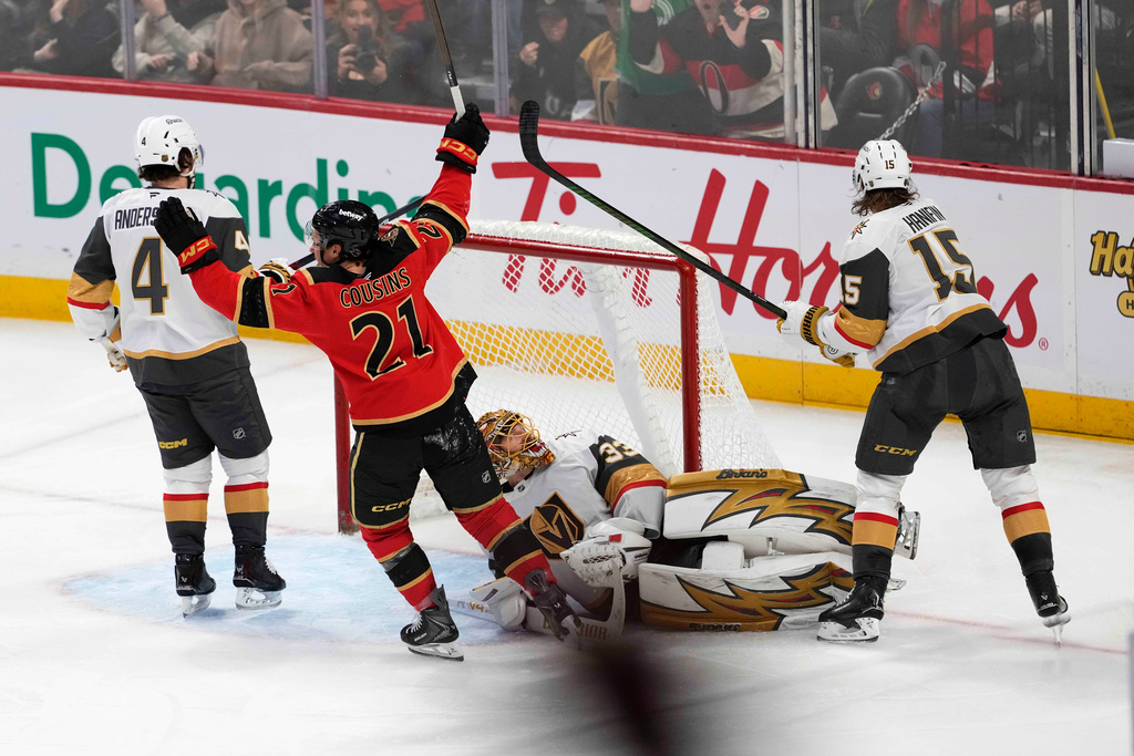 Ottawa Senators' Nick Cousins (21) celebrates after a goal teammate Nick Jensen (not shown) as Vegas Golden Knights goaltender Adin Hill (33) lies on the ice during third-period NHL hockey game action in Ottawa, Ontario, Sunday, Jan. 25, 2026. (Justin Tang/The Canadian Press via AP)