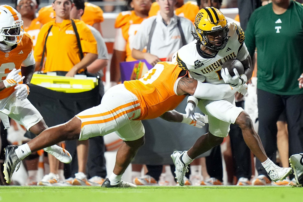 Kennesaw State wide receiver Zion Booker (4) runs the ball against Tennessee linebacker Amare Campbell (0) during the first half of an NCAA college football game Saturday, Sept. 19, 2026, in Knoxville, Tenn. (AP Photo/Camden Hall)