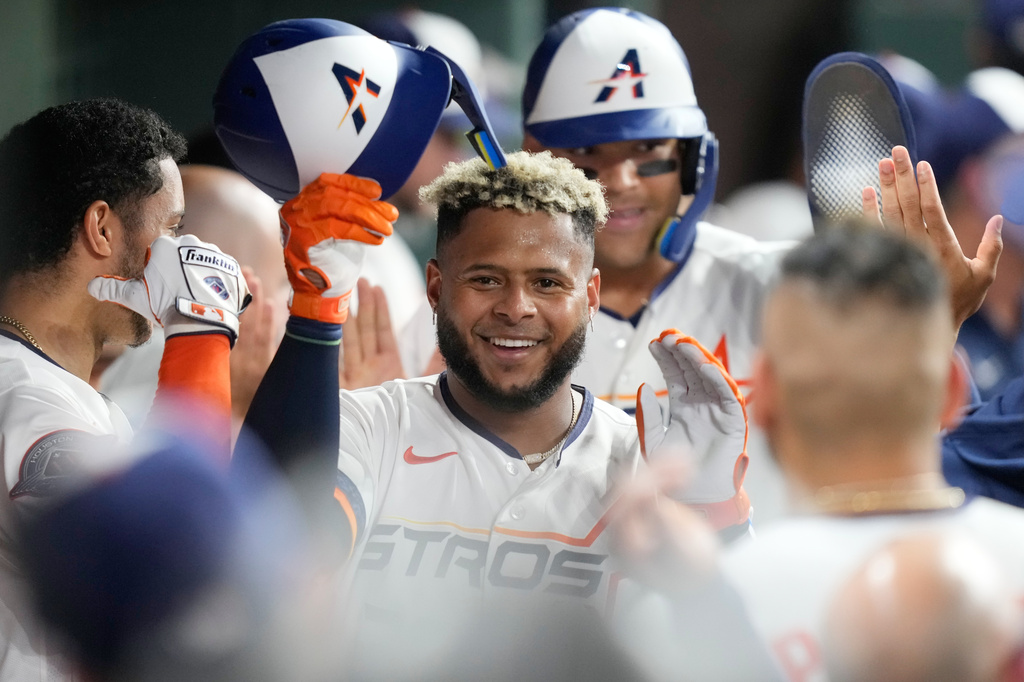 Houston Astros' Nelson Velázquez celebrates in the dugout after hitting a two-run home run against the Chicago White Sox during the fourth inning of a baseball game Monday, Aug. 31, 2026, in Houston. (AP Photo/David J. Phillip)