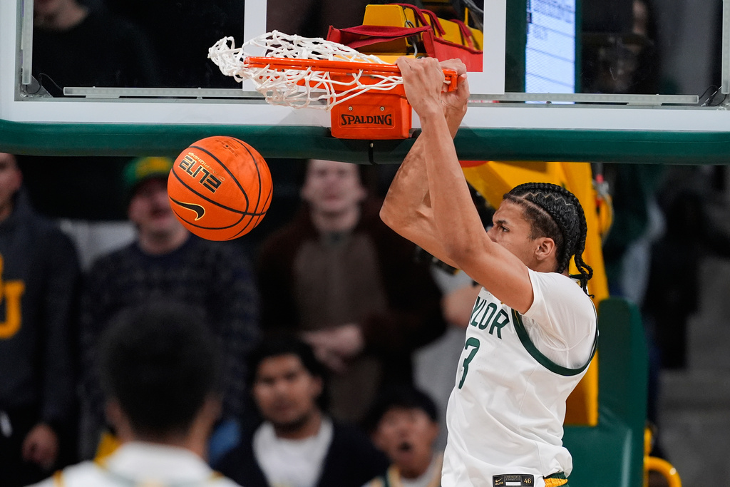 Baylor guard Cameron Carr dunks in the first half of an NCAA college basketball game against Arizona in Waco, Texas, Tuesday, Feb. 24, 2026. (AP Photo/Tony Gutierrez)