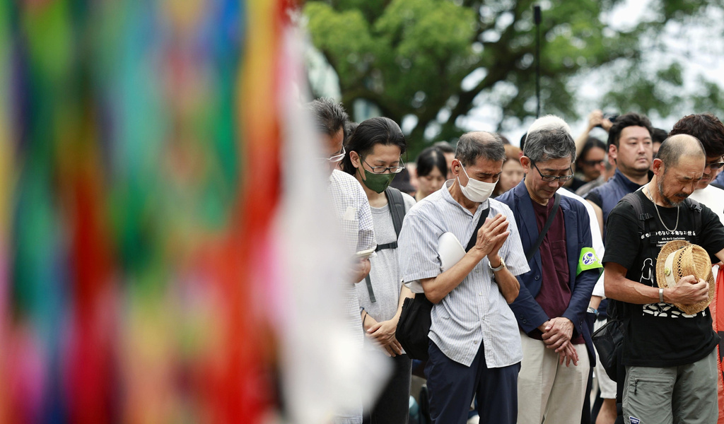 People observe a minute of silence during a ceremony to mark the 81st anniversary of the U.S. atomic bombing at the Atomic Bomb Hypocenter Park in Nagasaki, southern Japan Sunday, Aug. 9, 2026. (Kotaro Ueda/Kyodo News via AP)