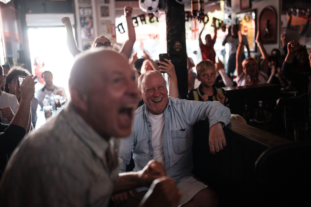 Fans celebrate after England's Harry Kane scored a goal as they watch a live broadcast of the World Cup Group L soccer match between England and Croatia at Ye Olde King's Head pub in Santa Monica, Calif., Wednesday, June 17, 2026. (AP Photo/Jae C. Hong)