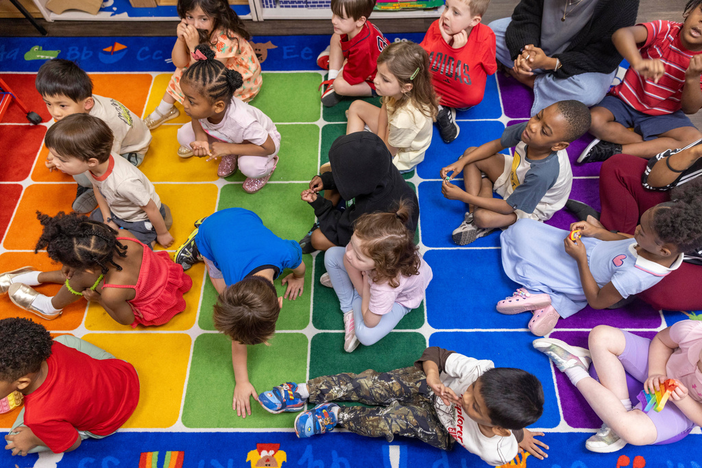 Georgia preschool students listen to a teacher read a book Wednesday, April 22, 2026, at The Capitol Hill Child Enrichment Center in Atlanta. (AP Photo/Alyssa Pointer)