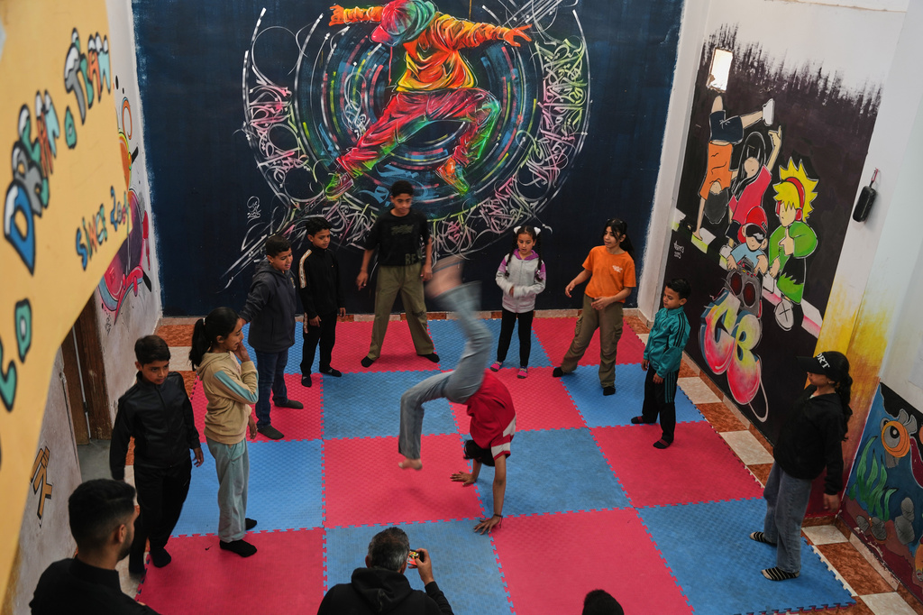 Palestinian children practice breakdancing in a dance studio in Nuseirat, central Gaza Strip, Monday, May 4, 2026. (AP Photo/Abdel Kareem Hana)