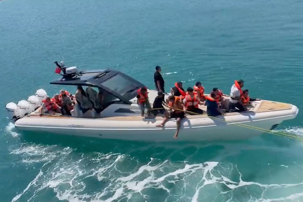 In this frame grab from video, rescued passengers wearing life jackets are evacuated by boat after a passenger vessel capsized off the coast of Girne, in the Turkish-occupied northern part of Cyprus, Sunday, Aug. 30, 2026. (DHA via AP)