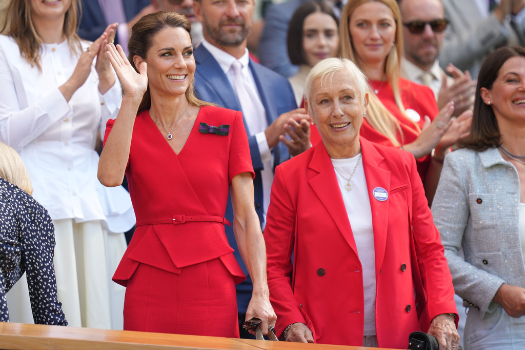 Britain's Princess Kate waves to the audience as she stands with former tennis player Martina Navratilova of the Czech Republic in the royal box on day 13 of the Wimbledon Tennis Championships in London, Saturday, July 11, 2026. (AP Photo/Kirsty Wigglesworth)