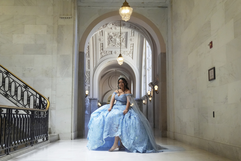 Abbie Gonzalez poses for her quinceañera portrait session at City Hall in San Francisco, Monday, Aug. 25, 2025. (AP Photo/Jeff Chiu)