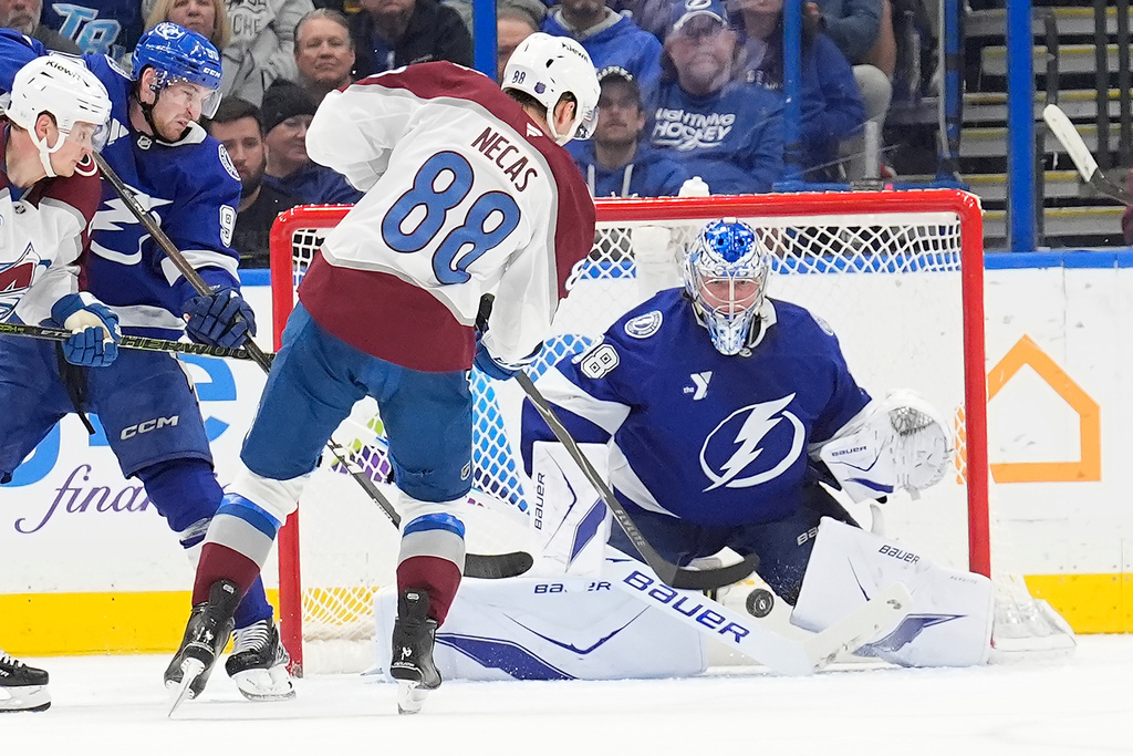 Tampa Bay Lightning goaltender Andrei Vasilevskiy (88) makes a save on a shot by Colorado Avalanche center Martin Necas (88) during the second period of an NHL hockey game Tuesday, Jan. 6, 2026, in Tampa, Fla. (AP Photo/Chris O'Meara)