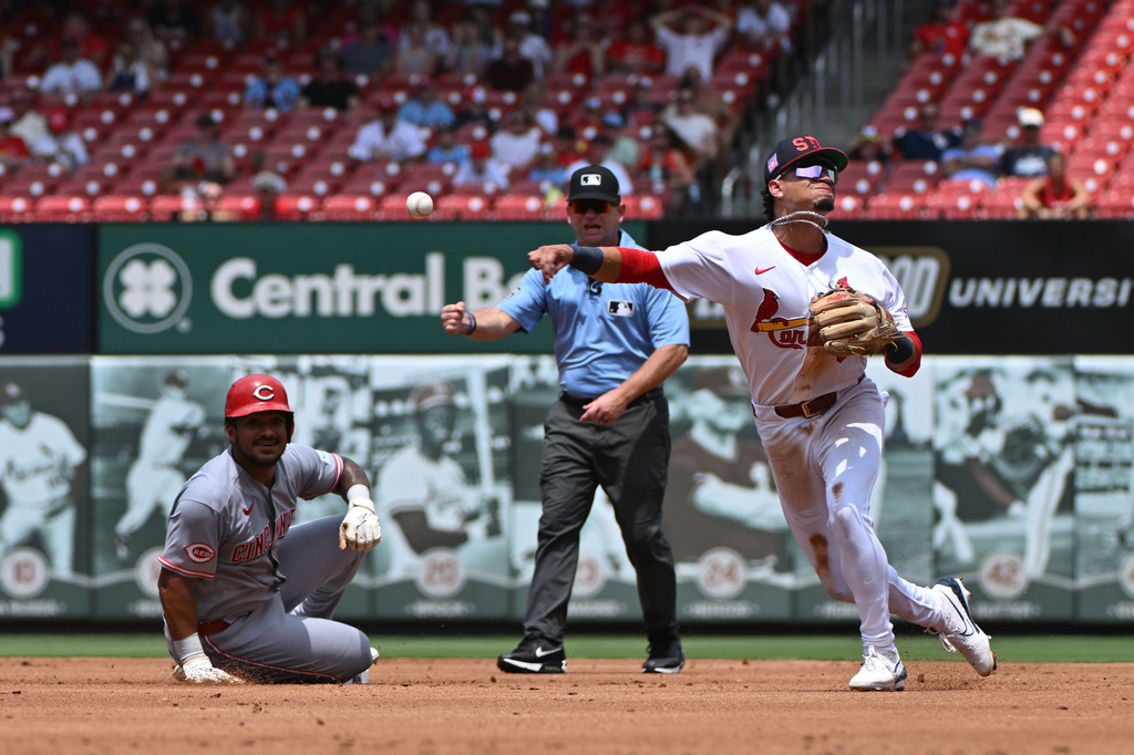 Cincinnati Reds' Dane Myers, left, is out as St. Louis Cardinals shortstop Masyn Winn, right, throws to first base during the second inning of a baseball game, Sunday, July 26, 2026, in St. Louis. (AP Photo/Jeff Le)