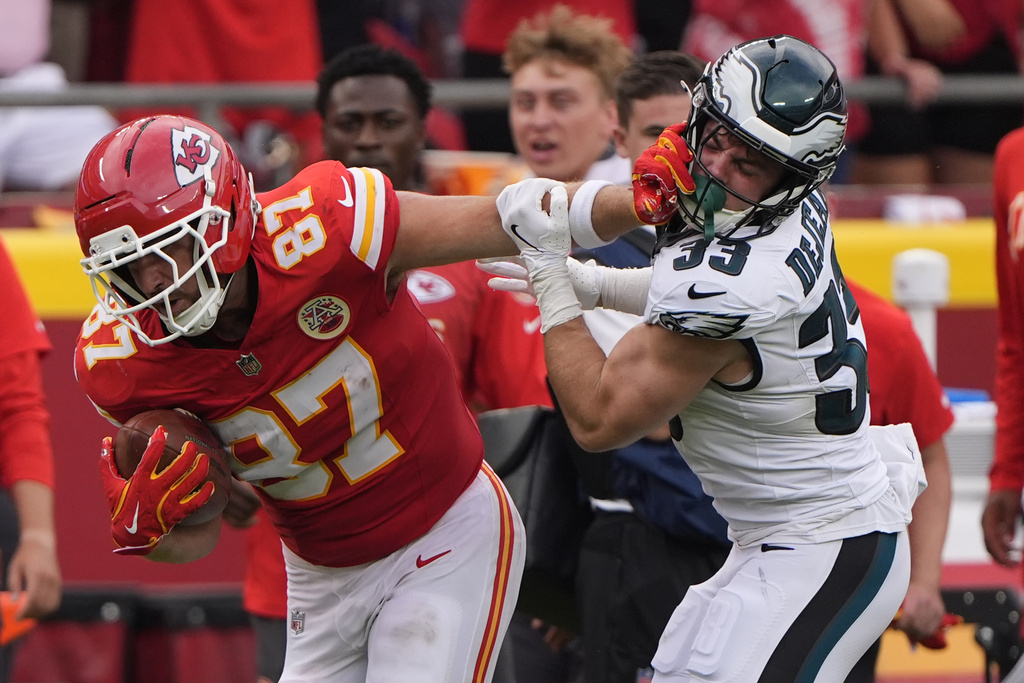 Kansas City Chiefs tight end Travis Kelce (87) runs for a first down as Philadelphia Eagles defensive back Cooper DeJean (33) defends during the second half of an NFL football game Sunday, Sept. 14, 2025, in Kansas City, Mo. (AP Photo/Charlie Riedel)