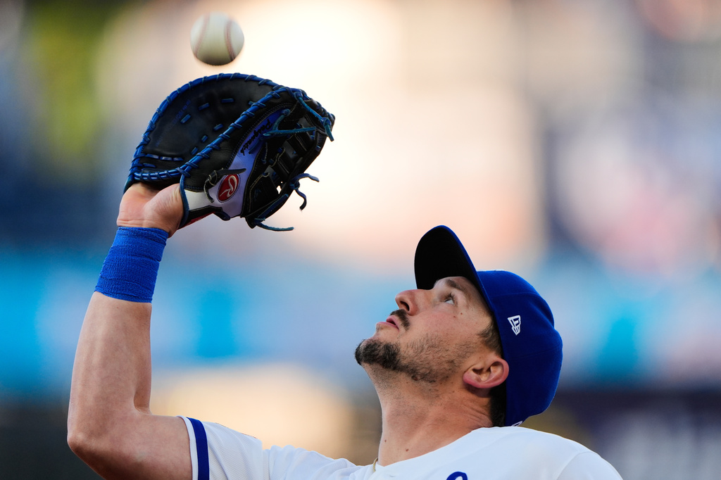 Kansas City Royals first baseman Vinnie Pasquantino catches a fly ball for the out on Cleveland Guardians' Rhys Hoskins during the third inning of a baseball game Wednesday, May 6, 2026, in Kansas City, Mo. (AP Photo/Charlie Riedel)