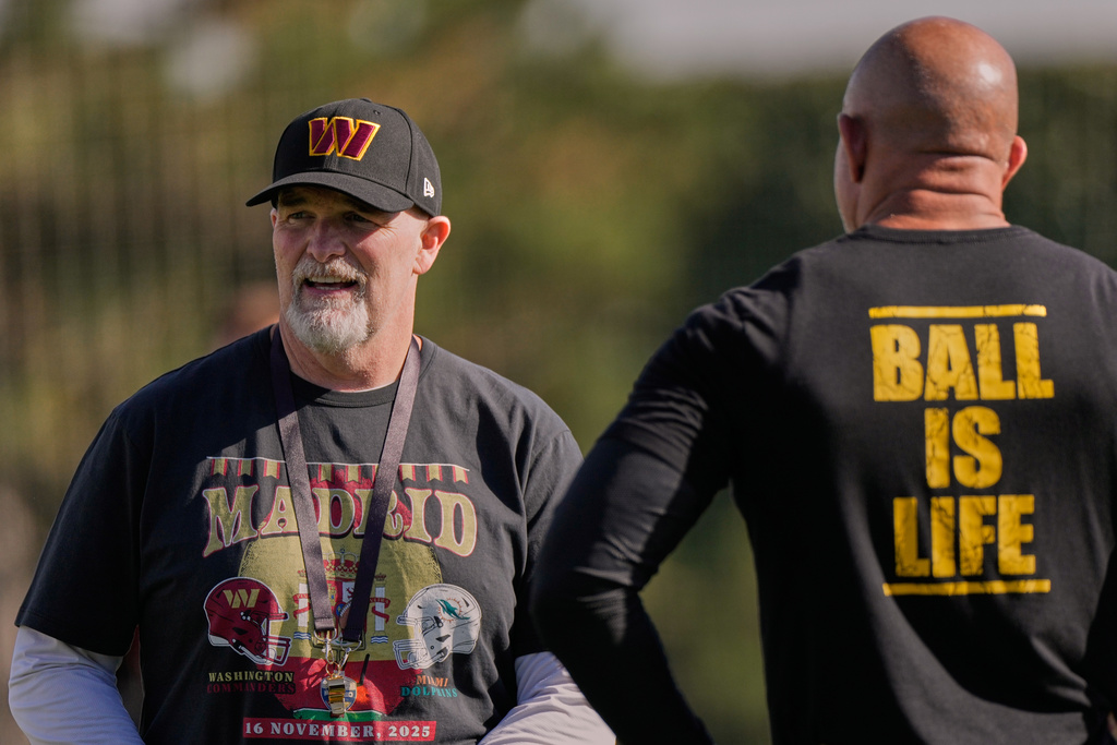 Washington Commanders head coach Dan Quinn, left, during a training session in Madrid, Spain, Wednesday, Nov. 12, 2025, ahead of Sunday's NFL football game against Miami Dolphins. (AP Photo/Bernat Armangue)