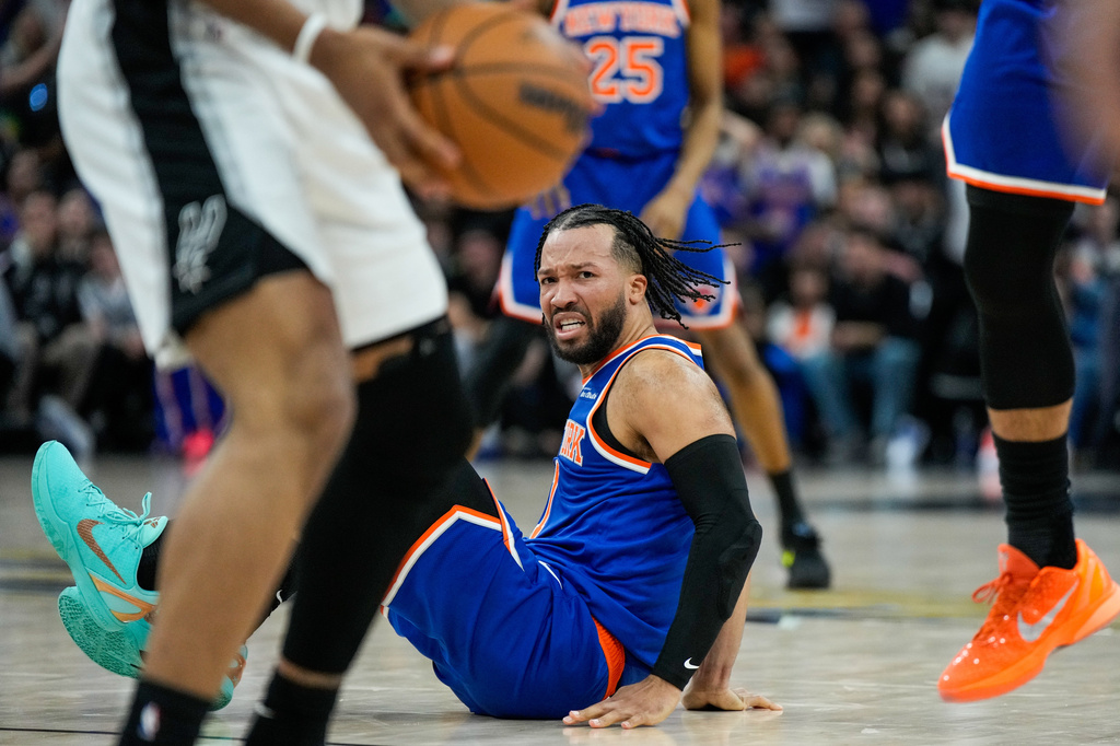 New York Knicks guard Jalen Brunson falls after a foul during the second half of Game 5 of the NBA Finals basketball series against the San Antonio Spurs, Saturday, June 13, 2026, in San Antonio. (AP Photo/Ross D. Franklin)