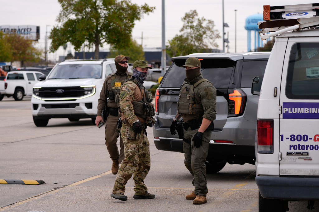 U.S. Border Patrol agents arrive at a Home Depot in Kenner, La.,Wednesday, Dec. 3, 2025. (AP Photo/Gerald Herbert)
