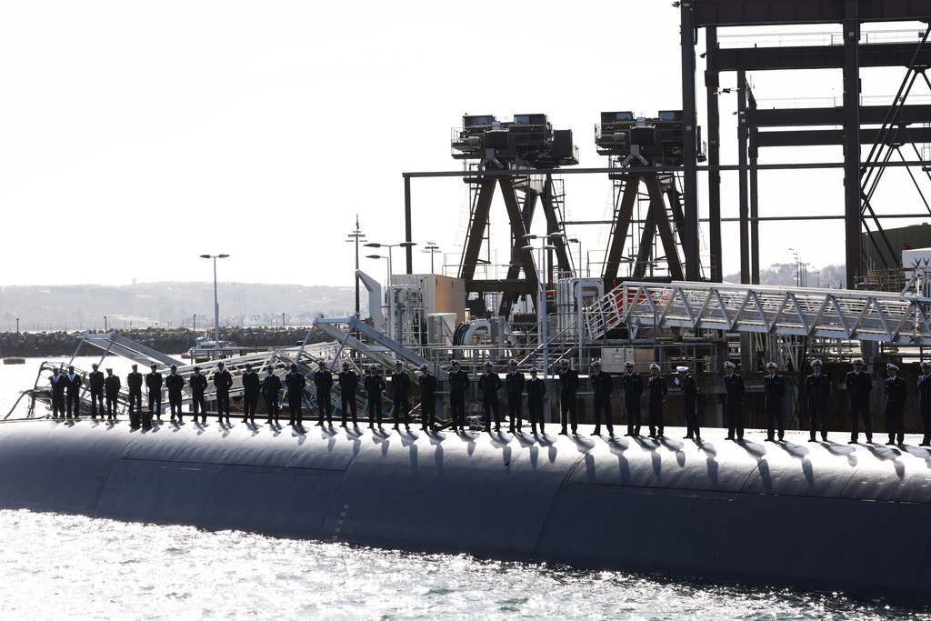 Members of the French Navy are aboard a submarine awaiting the arrival of French President Emmanuel Macron at the nuclear submarine navy base of Ile Longue in Crozon, France, Monday March 2, 2026. (Yoan Valat/Pool Photo via AP)