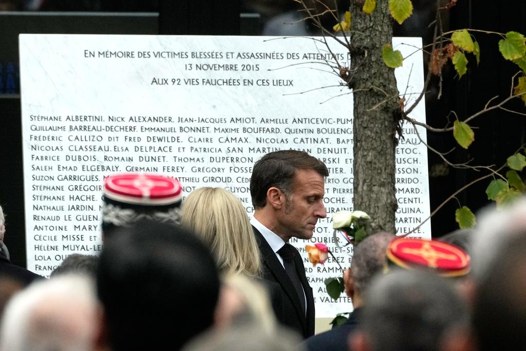 French President Emmanuel Macron walks past the plaque engraved with the names of the victims outside the Bataclan concert hall as Paris is marking the 10th anniversary of terrorist attacks that killed 132 people and injured hundreds, Thursday, Nov. 13, 2025 in Paris. (AP Photo/Michel Euler)