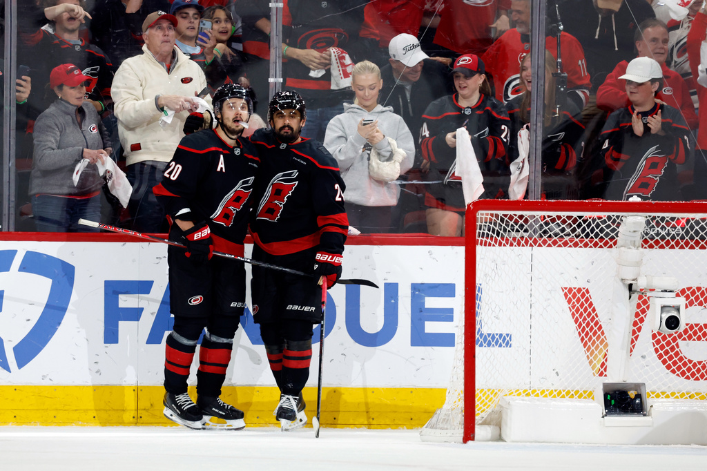 Carolina Hurricanes' Sebastian Aho (20) and Seth Jarvis, right, watch a replay of Jarvis' empty-net goal against the Montreal Canadiens during the third period in Game 5 of the Eastern Conference finals NHL hockey Stanley Cup playoff series in Raleigh, N.C., Friday, May 29, 2026. (AP Photo/Karl DeBlaker)