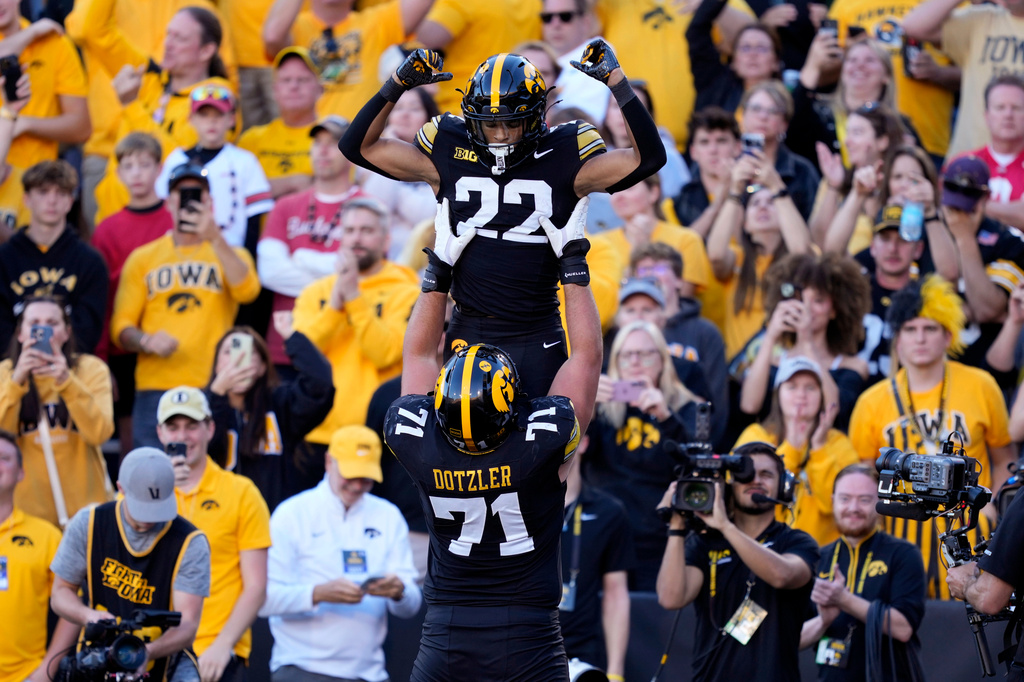 Iowa running back Braeden Jackson (22) celebrates with offensive lineman Jack Dotzler (71) after scoring a touchdown during the second half of an NCAA college football game against Ohio State, Saturday, Oct. 3, 2026, in Iowa City, Iowa. (AP Photo/Charlie Neibergall)