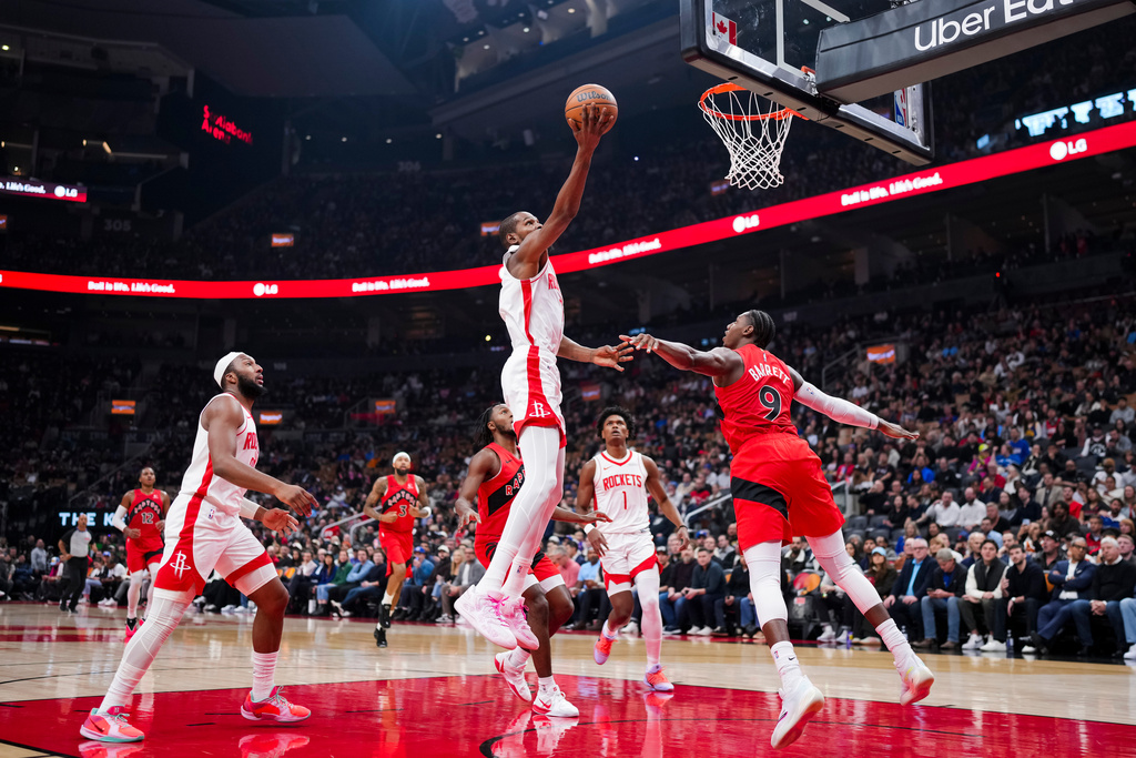 Houston Rockets forward Kevin Durant (7) drives the net during the first half of preseason NBA basketball action in Toronto, Wednesday, Oct. 29, 2025. (Thomas Skrlj/The Canadian Press via AP)
