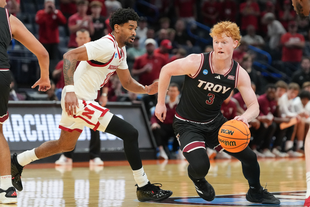 Troy guard Cooper Campbell, right, pushes past Nebraska guard Jamarques Lawrence during the first half in the first round of the NCAA college basketball tournament, Thursday, March 19, 2026, in Oklahoma City. (AP Photo/Kyle Phillips)