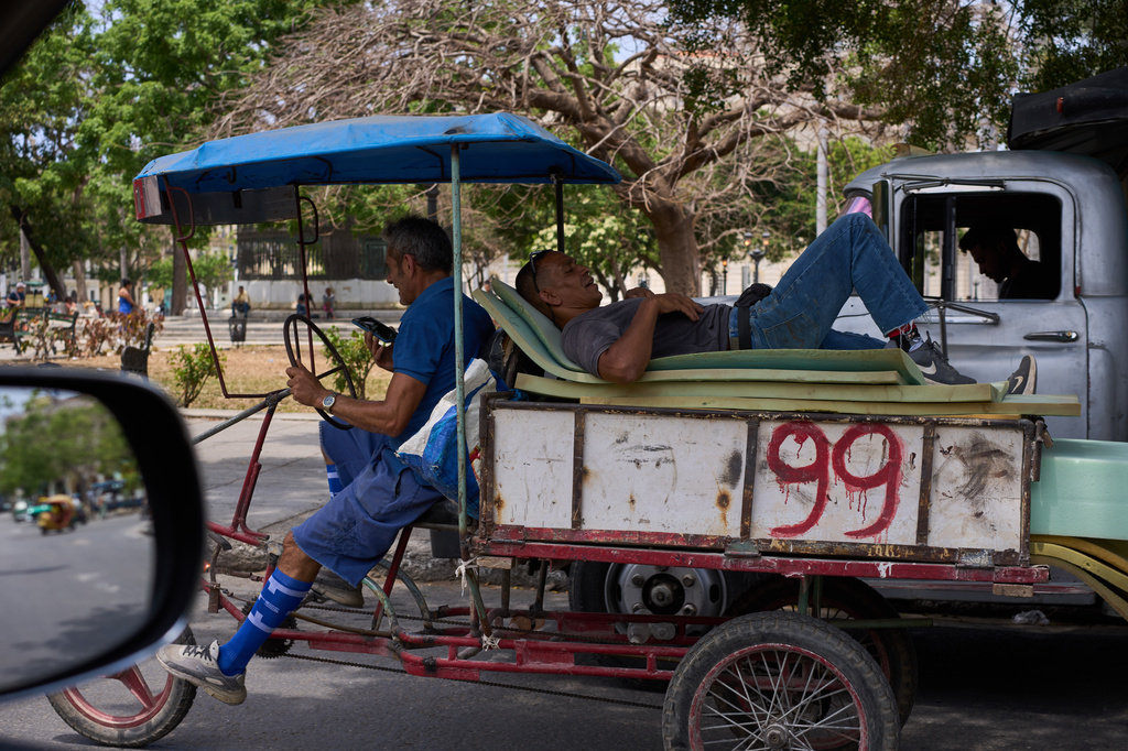 A man rests on mattresses atop a bicycle trailer in Havana, Wednesday, April 22, 2026. (AP Photo/Ramon Espinosa)