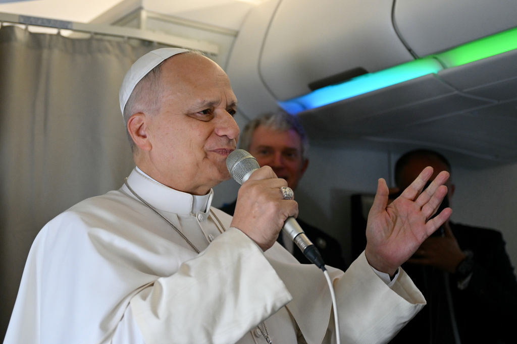 Pope Leo XIV speaks to journalists aboard his flight bound for Algiers’ Houari Boumédiène International Airport on Monday, April 13, 2026, at the start of an 11-day apostolic journey to Africa. (Alberto Pizzoli/Pool Photo via AP)