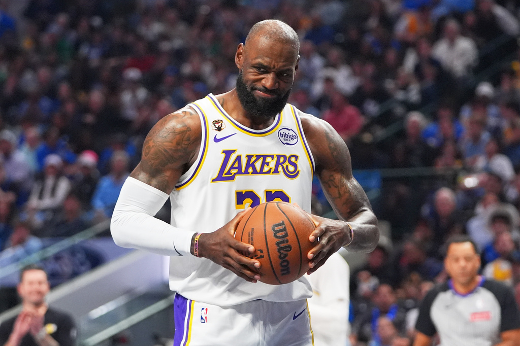 Los Angeles Lakers forward LeBron James grimaces as he grabs the ball after a whistle during the first half of an NBA basketball game against the Dallas Mavericks in Dallas, Sunday, April 5, 2026. (AP Photo/LM Otero)