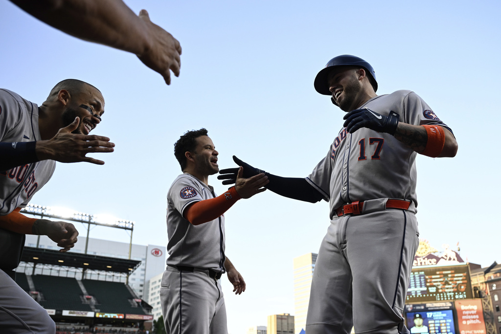 Houston Astros' Victor Caratini (17) is greeted by teammates after hitting a two run home run which scored Christian Walker hit against Baltimore Orioles pitcher Dean Kremer during the first inning of a baseball game, Saturday, Aug. 23, 2025, in Baltimore. (AP Photo/Terrance Williams)
