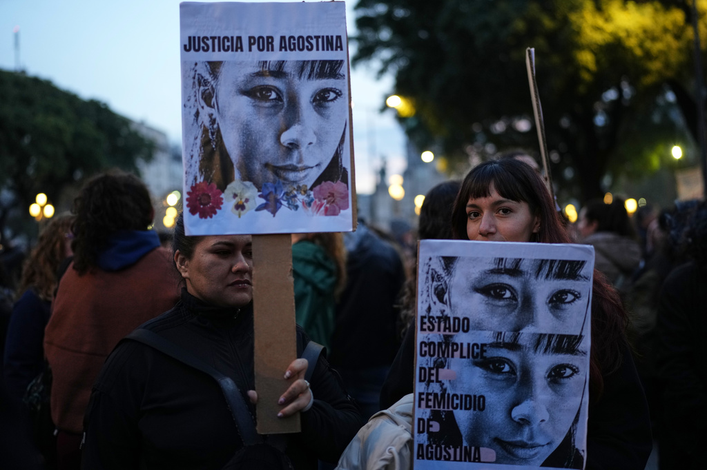 Demonstrators hold photos of 14-year-old Agostina Vega, who was murdered, during a march marking the anniversary of the "Ni Una Menos" (Not One Fewer) women's movement in Buenos Aires, Argentina, Wednesday, June 3, 2026. (AP Photo/Natacha Pisarenko)