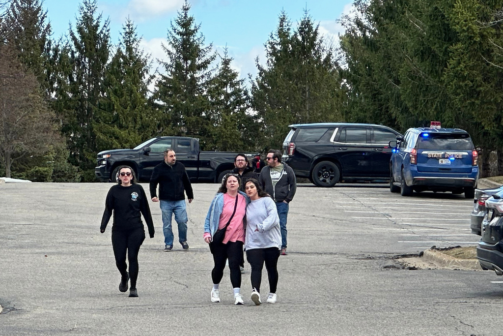 People gather near Temple Israel synagogue on Thursday, March 12, 2026, in West Bloomfield Township, Mich. (AP Photo/Corey Williams)