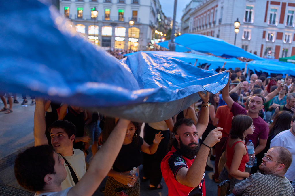 Protesters camp during a protest following the eviction last Wednesday of 87-year-old Maricarmen to demand stronger laws to protect renters, at Sol square in Madrid, Spain, Sunday, Sept. 27, 2026. (AP Photo/Manu Fernandez)