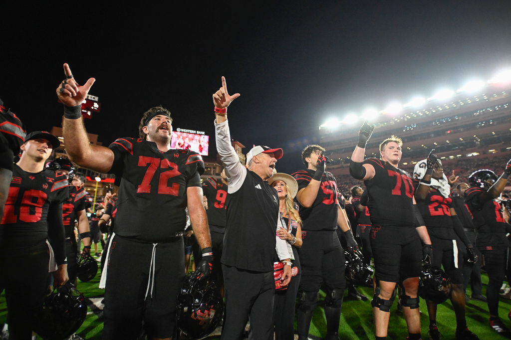 Texas Tech head coach Joey McGuire and his wife Debbie McGuire sing the Matador Song with the rest of the Texas Tech football team after winning an NCAA college football game against Houston Friday, Sept. 18, 2026, in Lubbock, Texas. (AP Photo/Justin Rex)