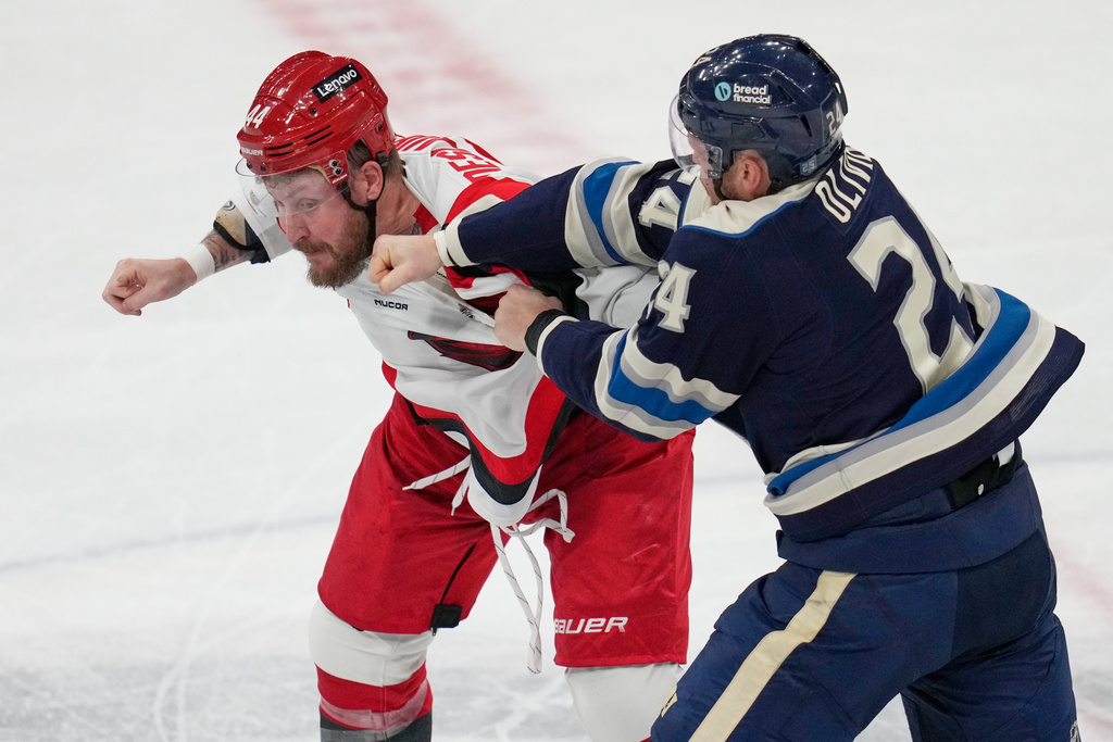 Columbus Blue Jackets' Mathieu Olivier (24) lands a punch on Carolina Hurricanes' Nicolas Deslauriers, left, in the second period of an NHL hockey game in Columbus, Tuesday, March 17, 2026. (AP Photo/Sue Ogrocki)