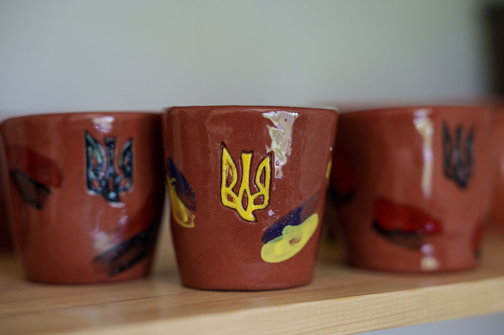 Clay cups decorated with Ukrainian triangle are seen inside apartments of blind Ukrainian war veteran Ivan Shostak in Vinnytsia, Ukraine, on May 21, 2026. (AP Photo/Evgeniy Maloletka)