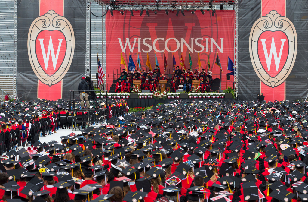 FILE - Graduates listen to the commencement address during graduation at the University of Wisconsin in Madison, Wis., May 12, 2018. (AP Photo/Jon Elswick, File)