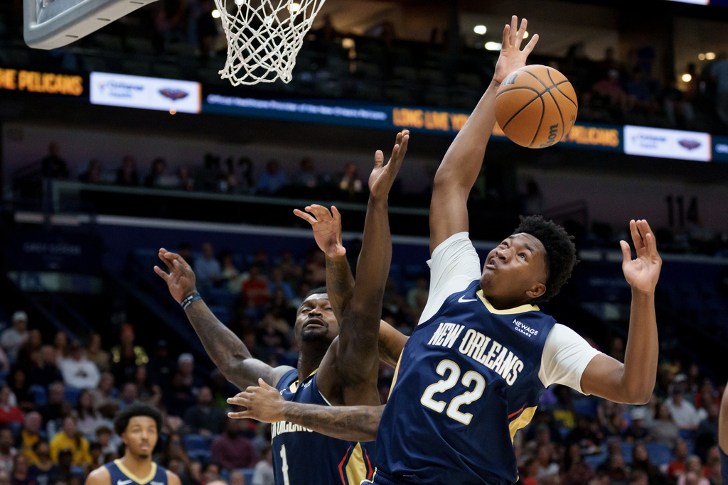 New Orleans Pelicans center Derik Queen (22) and forward Zion Williamson (1) go up for a rebound against the Indiana Pacers during the first half of an NBA basketball game in New Orleans, Saturday, Dec. 20, 2025. (AP Photo/Matthew Hinton)