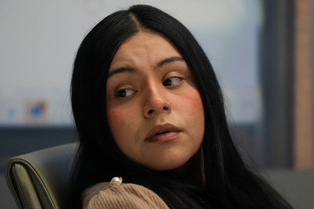 Marimar Martinez, a woman who was shot by a Border Patrol agent last year, sits with her attorneys during a press conference Wednesday, Feb. 11, 2026, in Chicago. (AP Photo/Erin Hooley)