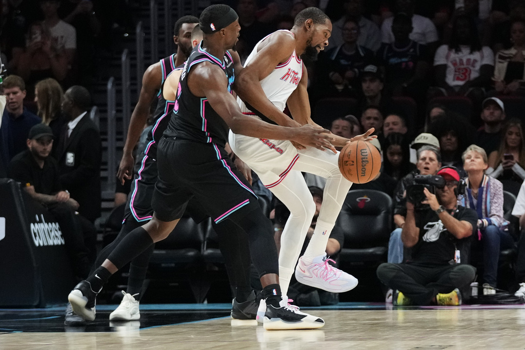 Houston Rockets forward Kevin Durant, right, loses control of the ball as Miami Heat center Bam Adebayo, left, defends during the first half of an NBA basketball game, Saturday, Feb. 28, 2026, in Miami. (AP Photo/Lynne Sladky)