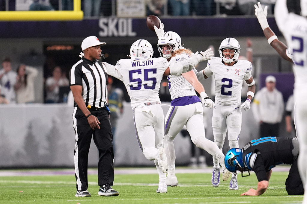 Minnesota Vikings linebacker Andrew van Ginkel, center, celebrates with linebacker Eric Wilson, left, and cornerback Isaiah Rodgers after recovering a fumble by Detroit Lions quarterback Jared Goff during the second half of an NFL football game, Thursday, Dec. 25, 2025, in Minneapolis. (AP Photo/Abbie Parr)