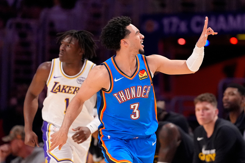Oklahoma City Thunder guard Jared McCain, right, gestures after scoring as Los Angeles Lakers forward Adou Thiero runs behind during the first half of Game 3 in a second-round NBA basketball playoffs series Saturday, May 9, 2026, in Los Angeles. (AP Photo/Mark J. Terrill)