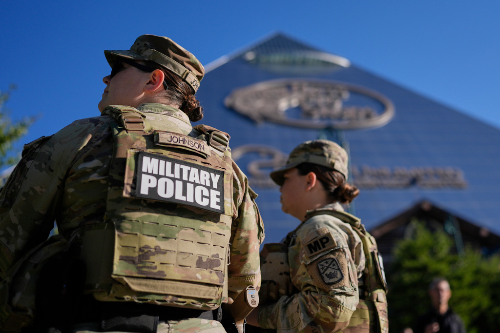 Members of National Guard patrol outside a Bass Pro Shops, Friday, Oct. 10, 2025, in Memphis, Tenn. (AP Photo/George Walker IV)