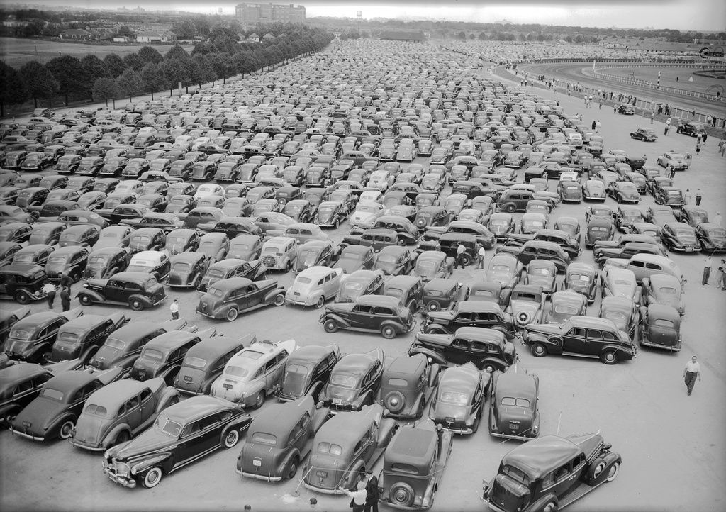 FILE - Thousands of autos jam the parking lot for the opening day of horse racing at the Aqueduct Racetrack in Queens borough of New York, Sept. 3, 1945. (AP Photo/John Lent, File)