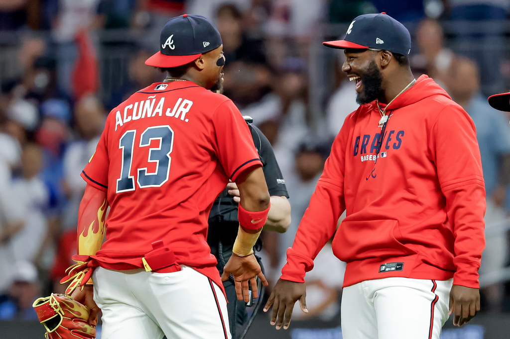 Atlanta Braves' Ronald Acuna Jr. (13) and Michael Harris II, right, celebrate after their team defeated the Philadelphia Phillies in a baseball game, Friday, April 24, 2026, in Atlanta. (AP Photo/Erik S. Lesser)